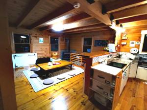 a large kitchen with a table and a stove at Nasusanso - Vacation STAY 9643 in Nasu-yumoto +24 photos