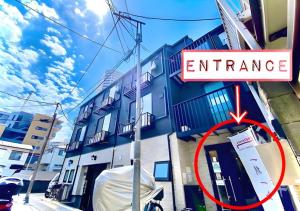 a sign on the side of a building with an entrance at Eternity APARTMENT HOTEL Shinagawa - Vacation STAY 01962v in Tokyo