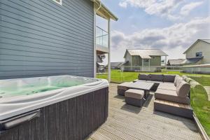 a hot tub on the deck of a house at Host & Stay - Bayview Lodge in Beadnell +21 photos