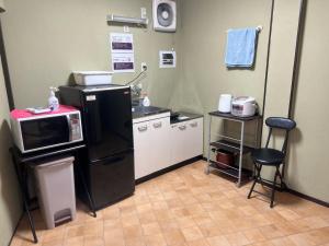 a kitchen with a black refrigerator and a microwave at Osaka - House - Vacation STAY 9690 in Osaka +53 photos