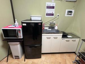 a small kitchen with a microwave and a sink at Osaka - House - Vacation STAY 9690 in Osaka