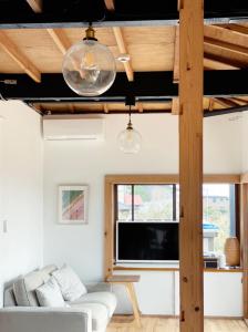 a living room with a couch and a tv at and SEA Kamogawa - Vacation STAY 07561v in Kamogawa