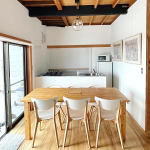a kitchen and dining room with a wooden table and chairs at and SEA Kamogawa - Vacation STAY 07561v in Kamogawa