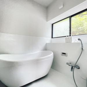 a white bathroom with a tub and a sink at and SEA Kamogawa - Vacation STAY 07561v in Kamogawa