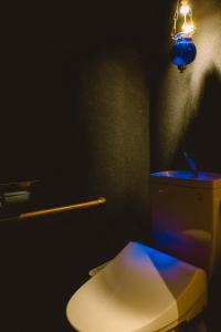 a bathroom with a white toilet in a dark room at Higurashi - Vacation STAY 07484v in Kyoto