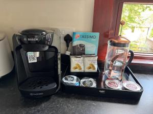 a coffeemaker and coffee maker sitting on a counter at situated at the heart of fort william in Fort William +9 photos
