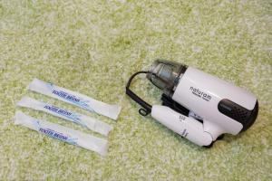 a hair dryer sitting on the ground with three needles at Good Life Apartment - Vacation STAY 08492v in Naha