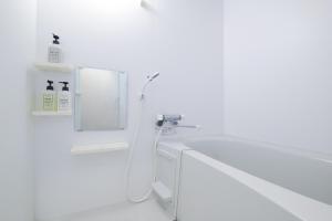 a white bathroom with a shower and a sink at Good Life Apartment - Vacation STAY 08492v in Naha +26 photos