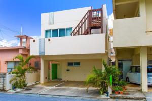 an apartment building with a car parked in front of it at Chatan villa Uminosoba - Vacation STAY 08585v in Hamakawa