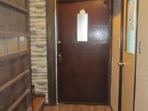 a wooden door in a room with a brick wall at Marina and Numazu sweet 1F - Vacation STAY 16710v in Numazu