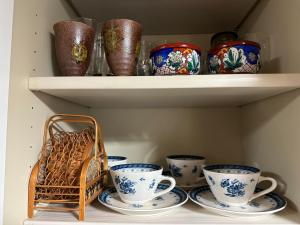 a shelf filled with cups and plates and a basket at Marina and Numazu sweet 1F - Vacation STAY 16710v in Numazu +20 photos