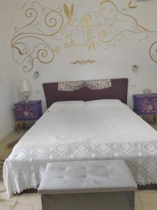 a bedroom with a bed with a white comforter at Giardino Principi Dafagi in Capurso +31 photos