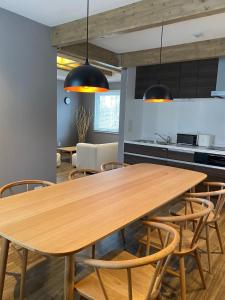 a kitchen and dining room with a wooden table and chairs at KAMMA - Vacation STAY 12882v in Kutchan