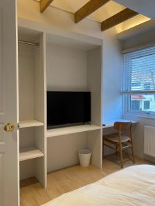 a bedroom with a tv and a bed and a desk at KAMMA - Vacation STAY 12882v in Kutchan