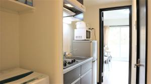 a small kitchen with a sink and a refrigerator at Credo Maison Kamakura - Vacation STAY 10347 in Kamakura +6 photos