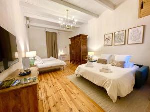 a large room with two beds and a table at Les Herbes Blanches - Gîte privé - calme & nature, rivière in Grospierres +20 photos