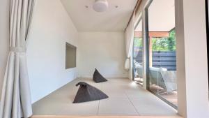 a living room with a large window and two chairs at Karuizawa House Villa - Vacation STAY 16941v in Oiwake