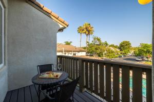 a balcony with a table with a tray of food on it at Redecorated - Serene- Legoland- Family-Friendly in Carlsbad