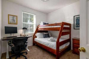 a bedroom with a bunk bed and a desk with a computer at Redecorated - Serene- Legoland- Family-Friendly in Carlsbad