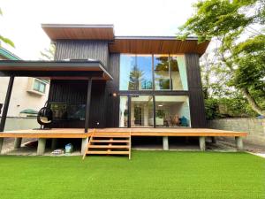 a house with a deck and a large window at Karuizawa House Villa - Vacation STAY 08359v in Oiwake