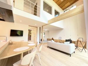 a living room with a white couch and a table at Karuizawa House Villa - Vacation STAY 08359v in Oiwake