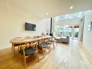 un soggiorno con tavolo e sedie in legno di Karuizawa House Villa - Vacation STAY 16963v a Oiwake
