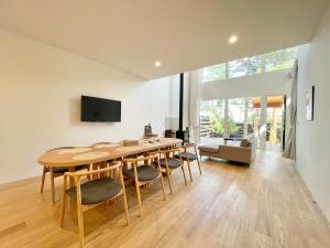 a dining room with a wooden table and chairs at Karuizawa House Villa - Vacation STAY 16971v in Oiwake +7 photos