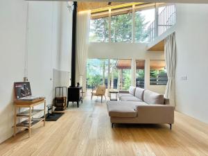 a living room with a couch and a table at Karuizawa House Villa - Vacation STAY 16971v in Oiwake