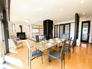 a dining room and living room with a table and chairs at Karuizawa House Villa - Vacation STAY 27625v in Oiwake +31 photos