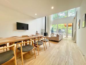 a living room with a long wooden table and chairs at Karuizawa House Villa - Vacation STAY 16955v in Oiwake