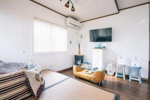 a living room with a couch and a tv at House number 7106 - Vacation STAY 10493 in Furugen