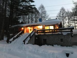 a house covered in snow with lights at New Togakushi Sea Hail - Vacation STAY 61073v in Nagano