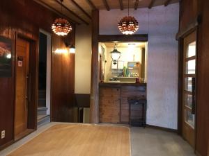 a hallway with two chandeliers and a kitchen at New Togakushi Sea Hail - Vacation STAY 51752v in Nagano +9 photos