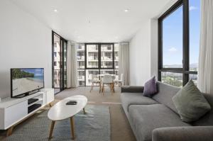 a living room with a couch and a tv at Broadbeach 806 in Gold Coast