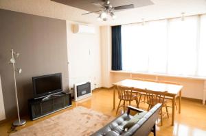 a living room with a couch and a table at STAY IN TOKIWA - Vacation STAY 16336v in Asahikawa