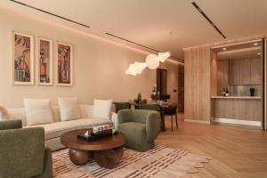 a living room with a couch and chairs and a table at Fanaya Jeddah - فنايا جدة in Jeddah