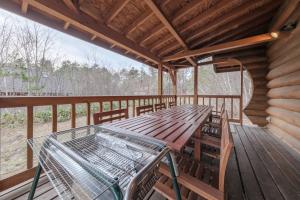 a wooden porch with a table and chairs on a deck at Shakunagedaira Rental Cottage - Vacation STAY 18468v in Numajiri