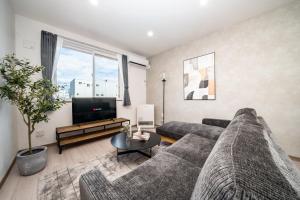 a living room with a couch and a tv at Mks 202 in Asahikawa +95 photos