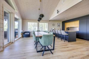 a dining room with a long table and chairs at Luxury Villa Havu in Himos +35 photos