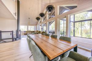a large room with a wooden table and chairs at Luxury Villa Havu in Himos