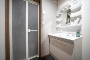 a bathroom with a shower and a sink and a mirror at Mks 202 in Asahikawa