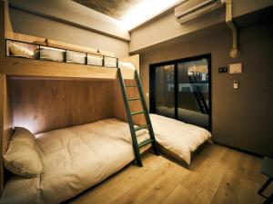 a bunk bed in a small room with a ladder at Rakuten STAY Fukuoka Yakuin Bunk bed Triple Room in Fukuoka +23 photos