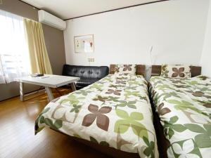 a bedroom with a bed and a table in it at Flat piece chair house - Vacation STAY 40366v in Fuzuchi +33 photos