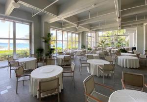 a dining room with tables and chairs and windows at Flat piece chair house - Vacation STAY 40366v in Fuzuchi