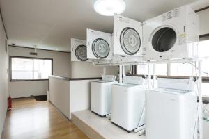 a laundry room with four washer and dryers on display at Flat piece chair house - Vacation STAY 34091v in Fuzuchi