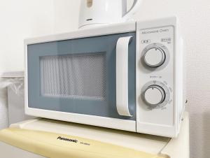 a microwave oven sitting on top of a shelf at Flat piece chair house - Vacation STAY 40368v in Fuzuchi