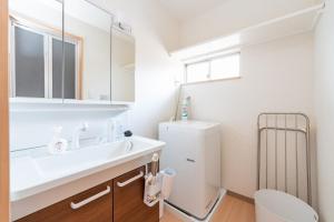 a white bathroom with a sink and a toilet at Shinjuku-ku - House - Vacation STAY 17230 in Tokyo +49 photos