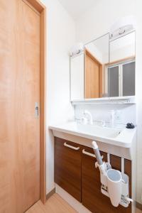 a bathroom with a sink and a mirror at Shinjuku-ku - House - Vacation STAY 17230 in Tokyo