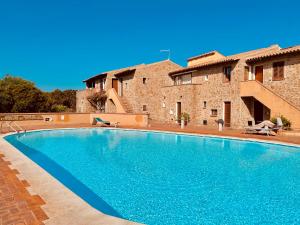 a large swimming pool in front of a house at Baja Sardinia CB 1 with Pool 100m from the Beach in Baja Sardinia