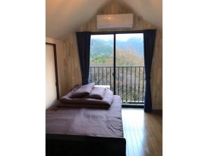 a room with a bed and a large window at Trust Maison Katase - Vacation STAY 24205v in Izu